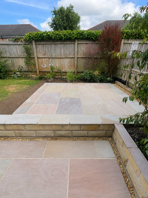 Raised patio in Raj sandstone with Yorkshire stone retaining wall Raised patio in Raj sandstone with Yorkshire stone retaining wall