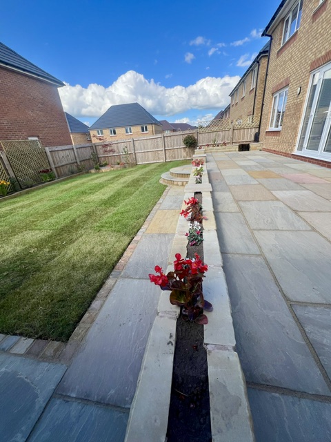 Raj sandstone raised patio with yorkshire stone walling Raj sandstone raised patio