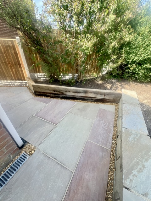 French Oak retainer and flower bed with raj sandstone flags French Oak retainer and flower bed with raj sandstone flags